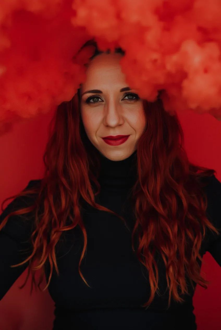 Tereza Škraňka — the auditor lens applied to marketing, red smoke portrait